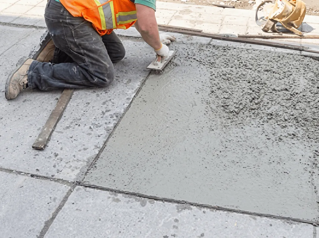 Professional repairing a concrete floor in Oklahoma City, OK