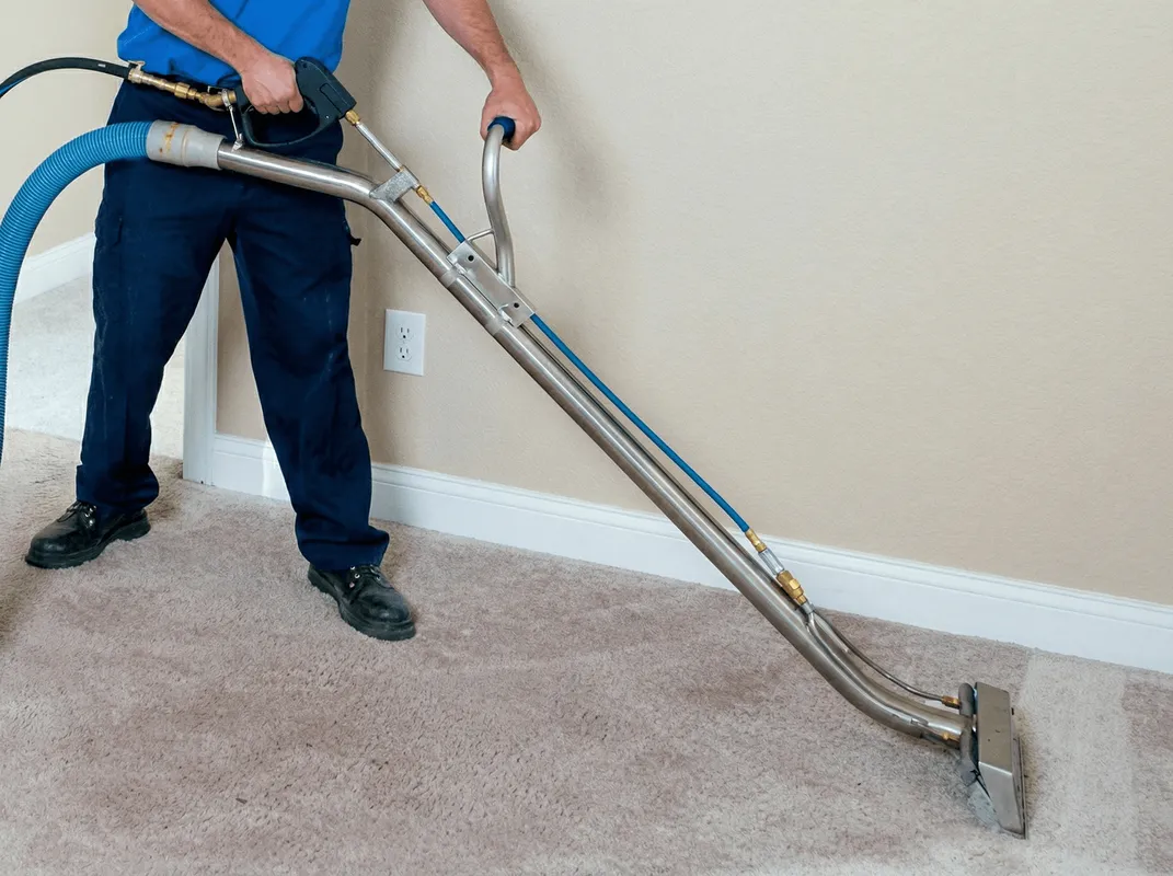 Professional operating a liquid removal machine on a carpeted floor in Oklahoma City, OK